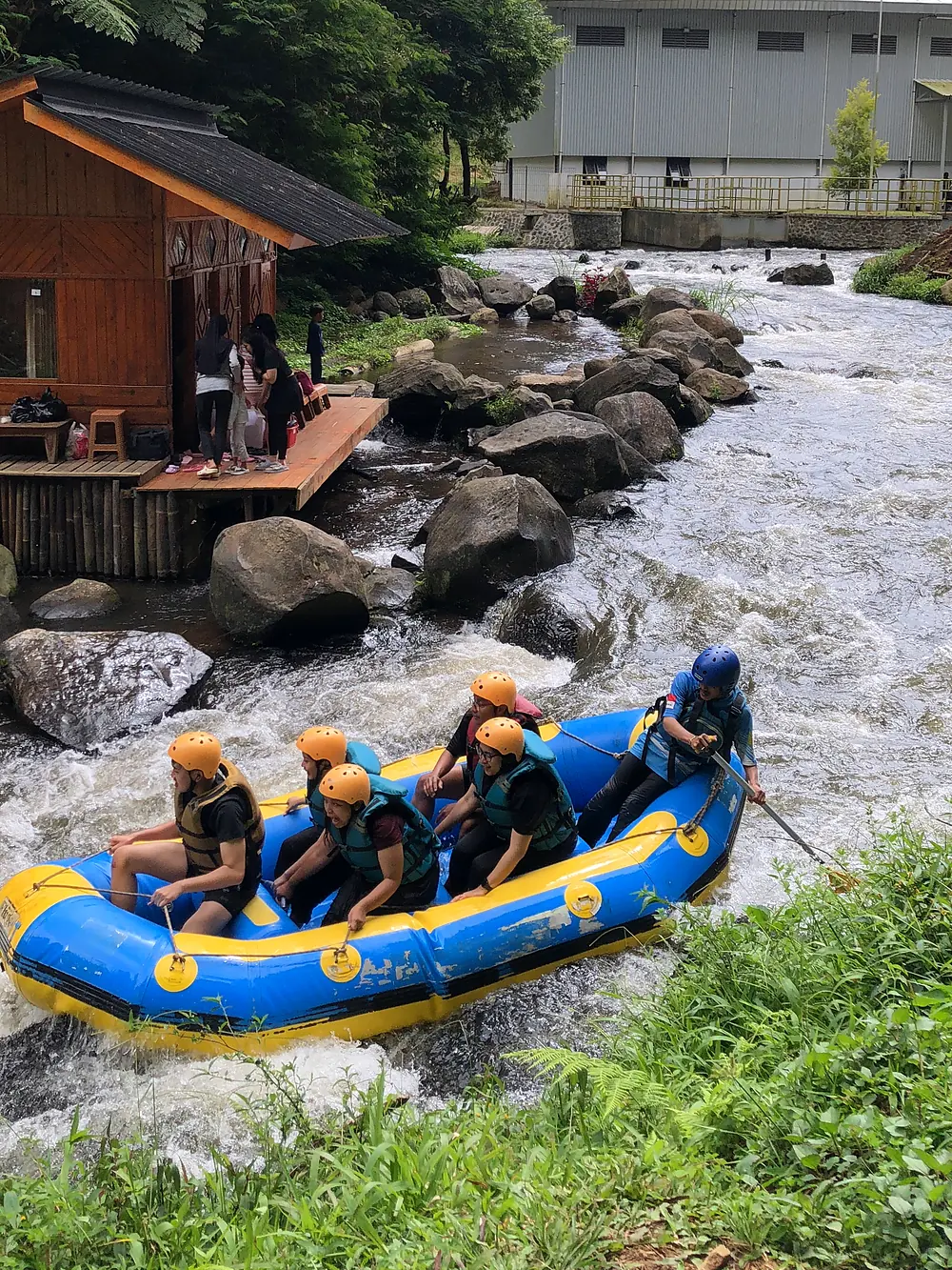 Rocky river in front of the wooden reception building